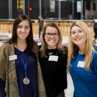 Three alumnae pose for a photo together at the Fowling Fun Event
